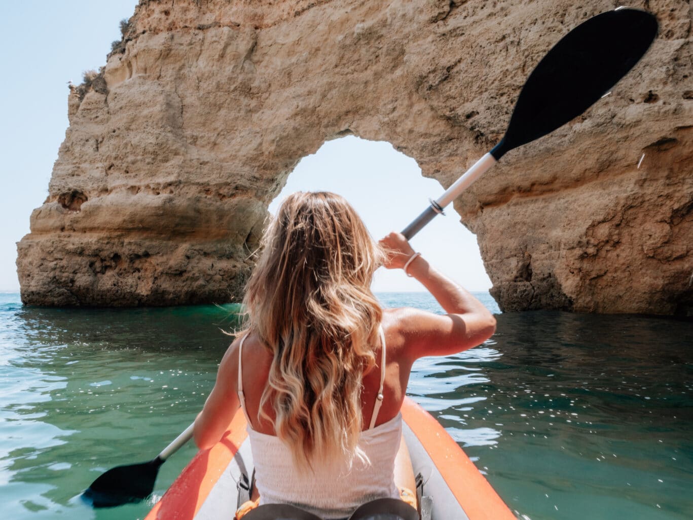 Rear view of woman on canoe